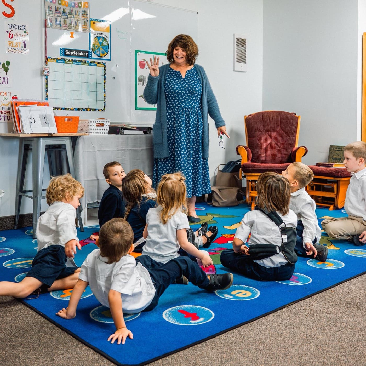 Kindergarten circle time on the alphabet rug